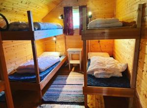 a room with three bunk beds in a cabin at Bakerstu in Skage i Namdalen