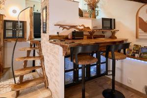 a kitchen with a desk with a computer on it at Loft Unique Romantique & Balnéothérapie in Riom +20 photos