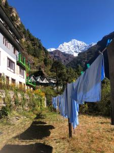 a laundry line with a mountain in the background at Hotel Waterfall Benkar in Phakding