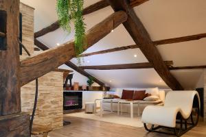 a living room with wooden ceilings and a fireplace at Loft Unique Romantique & Balnéothérapie in Riom