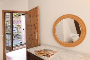 a bathroom with a mirror and a table at Rustico Alla Bolla - Val Verzasca - Happy Rentals in Frasco