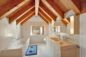 a bathroom with a tub and a sink and a toilet at Rustico Esterina in Val Verzasca for 4 - Happy Rentals in Lavertezzo