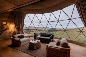 a living room with a large window in a tent at Valley Views Glamping in Kurow