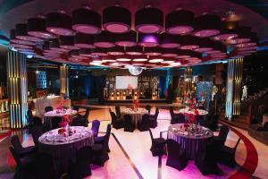 a banquet hall with tables and chairs and a stage at KARPYNĖ Restaurant & Bed & Breakfast in Gabšiai +17 photos