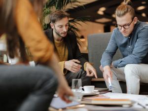 a group of men sitting around a table at ibis Saint-Die in Saint Die