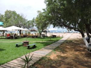 a park with benches and tables on the beach at Poseidon Studios in Georgioupolis