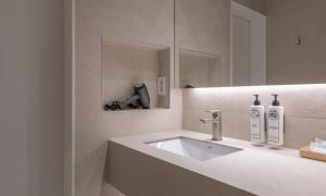a white bathroom with a sink and a mirror at Chuncheon Bom Stay in Chuncheon +56 photos