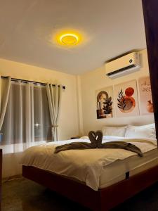 a bedroom with a large bed with a yellow light at Farm Village in San Juan