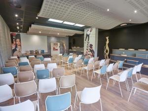 a room with rows of chairs and a waiting room at ibis Poitiers Site du Futuroscope in Chasseneuil-du-Poitou +148 photos