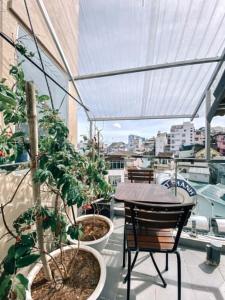 a balcony with a table and chairs and plants at Petite Dalat - Boutique Hotel in Da Lat