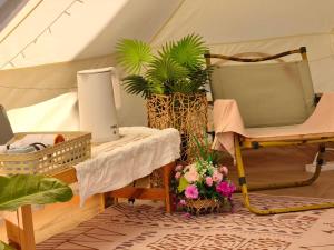 a room with a tent with a table and flowers at Nai Suan Phan Resort - ในสวนฝัน รีสอร์ท in Ban Thung Samoe