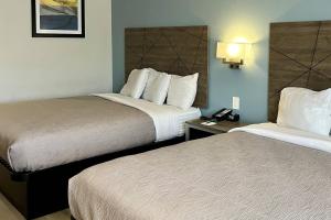 a hotel room with two beds and a telephone at Quality Inn Tracy I-205 in Tracy