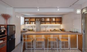 a kitchen with a large island with bar stools at Chuncheon Bom Stay in Chuncheon