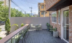 a patio with chairs and a table on a building at Chuncheon Bom Stay in Chuncheon