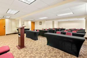 a conference room with red chairs and a podium at Quality Inn Edison-New Brunswick in Edison