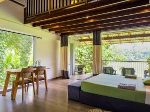 a bedroom with a bed and a table and a balcony at Leisure Land in Galle +181 photos