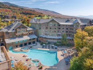 an aerial view of a resort with a swimming pool at The Lodge at Spruce Peak, a Destination by Hyatt Residence in Stowe