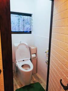 a bathroom with a toilet with the lid up at 아라무사aramoosa민숙 in Tsushima +8 photos