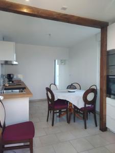 a kitchen with a table and chairs in a room at Garde barrières N 22 in Cholet