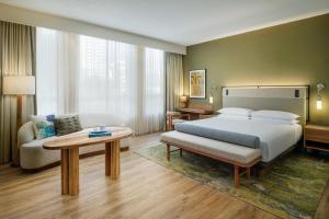 a hotel room with a bed and a couch at Hyatt Regency Panama City in Panama City