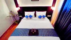 a hotel room with a bed with a purse on it at Asapian Vanyamahal - A Nature Resort in Rāmnagar +121 photos