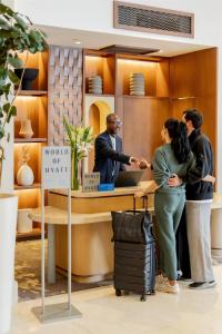 a group of people standing around a counter at Hyatt Regency Panama City in Panama City