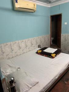 a bed in a room with a white mattress at Hotel Shabnam,Near Park St,New Market,Esplanade in Kolkata