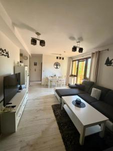 a living room with a couch and a table at Apartmán Lara -Lesná in Stará Lesná
