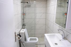 a white bathroom with a toilet and a sink at RİO's HOTEL KURTKÖY in Istanbul +15 photos
