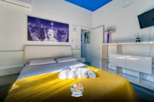 a bedroom with a bed with a yellow blanket at Casa Vacanza California in Bari