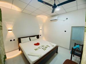 a bedroom with a bed and a ceiling fan at New Vilard in Tissamaharama