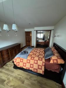 a bedroom with a large bed and a mirror at Apartament Centrum in Augustów