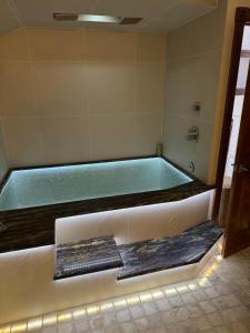 a bath tub in a bathroom with a green at Apartament Centrum in Augustów +21 photos
