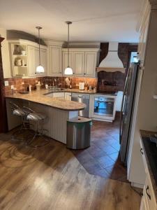 a kitchen with white cabinets and a island with a counter at Apartament Centrum in Augustów