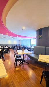 a restaurant with tables and chairs in a room at TEEDO Hotel Kuala Lumpur in Kuala Lumpur