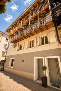 a building with flower boxes on the top of it at ES Apartments in Nago-Torbole