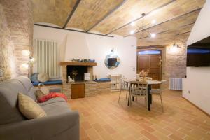 a living room with a couch and a table at Charme in Spello in Spello