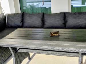 a leather couch with a sign sitting on top of it at Aurora suite in Nea Peramos +55 photos