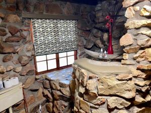 a stone room with a table in a stone wall at Rondeberg Holiday Resort in Clanwilliam +66 photos