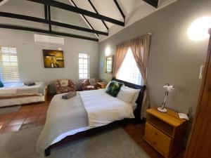 a bedroom with a large white bed and a couch at Rondeberg Holiday Resort in Clanwilliam