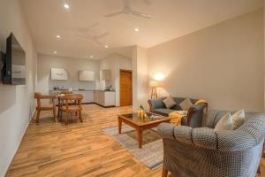 a living room with a couch and a table at Reejas inn's n' suites in Kasauli