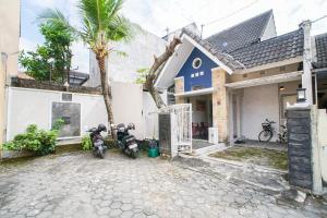 a couple of motorcycles parked in front of a house at Citra Condong Catur in Seturan