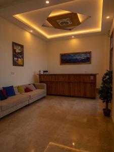 a living room with two couches and a ceiling at Hispar Hotel Skardu in Skardu