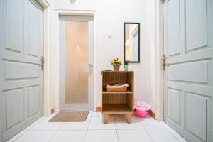 a hallway with doors and a shelf with a mirror at Citra Condong Catur in Seturan +25 photos