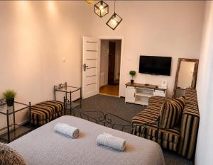 a living room with two chairs and a television at Apartament X in Przemyśl