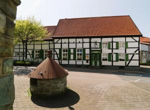 a building with a brown roof on a street at Willkommen bei Renate und Jörg in Unna