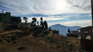 a view of a mountain with trees on a hill at Hotel Skyline in Kanatal