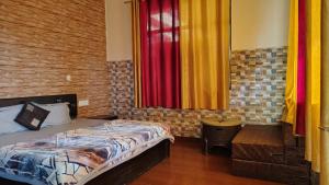 a bedroom with a bed and colorful curtains at Hotel Skyline in Kanatal +11 photos