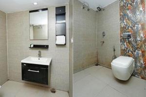a bathroom with a toilet and a sink at Hotel Grand In Near 2 Min From Vaishali Metro Station in Ghaziabad +31 photos