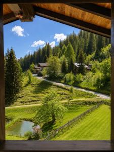 a view from a window of a field and a road at Frühstückspension Bachseitenhof in Radstadt +89 photos